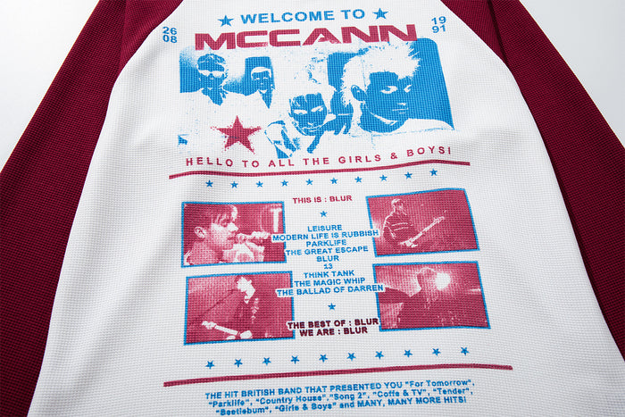Close-up of the white waffle-textured front graphic with blue and burgundy retro typography and panel artwork