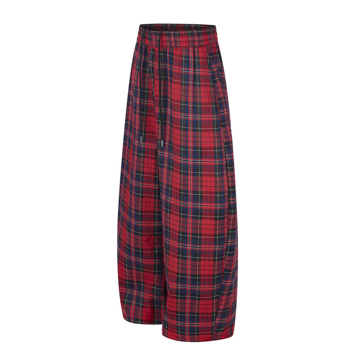 Angled front view of red and navy plaid wide-leg pants showing the elastic waist and loose fit