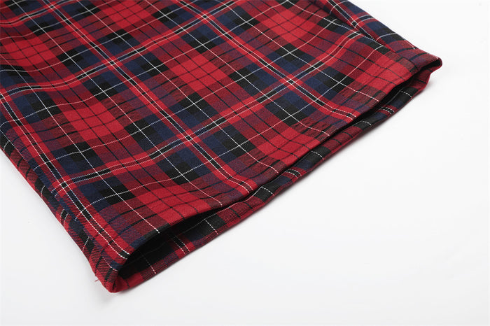 Close-up of a wide pant leg hem with neatly finished edges and red plaid pattern