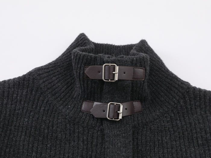 Close-up of the ribbed cardigan mock neck with two brown leather buckle straps and metal hardware