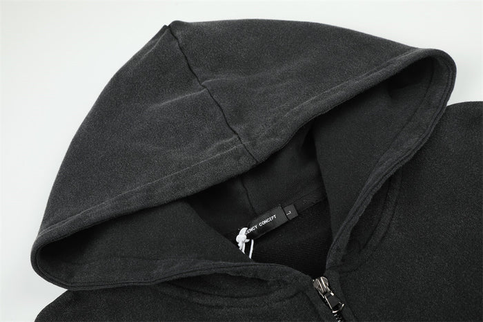 Close-up of the black hoodie hood showing stitched edges, inner label, and partially visible zipper