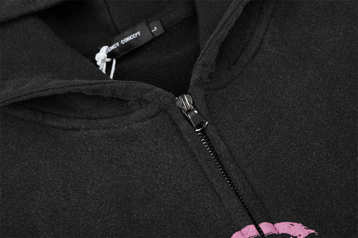 Close-up of the black hoodie neckline with inner label and metal zipper pull