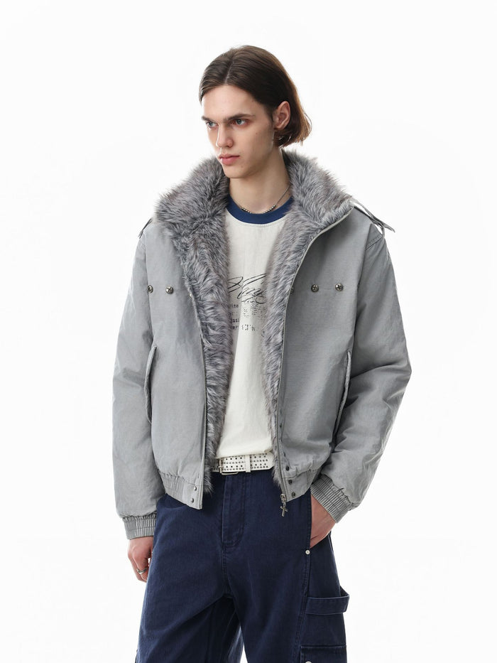 Model wearing a light gray bomber jacket with gray faux fur collar and front stud accents