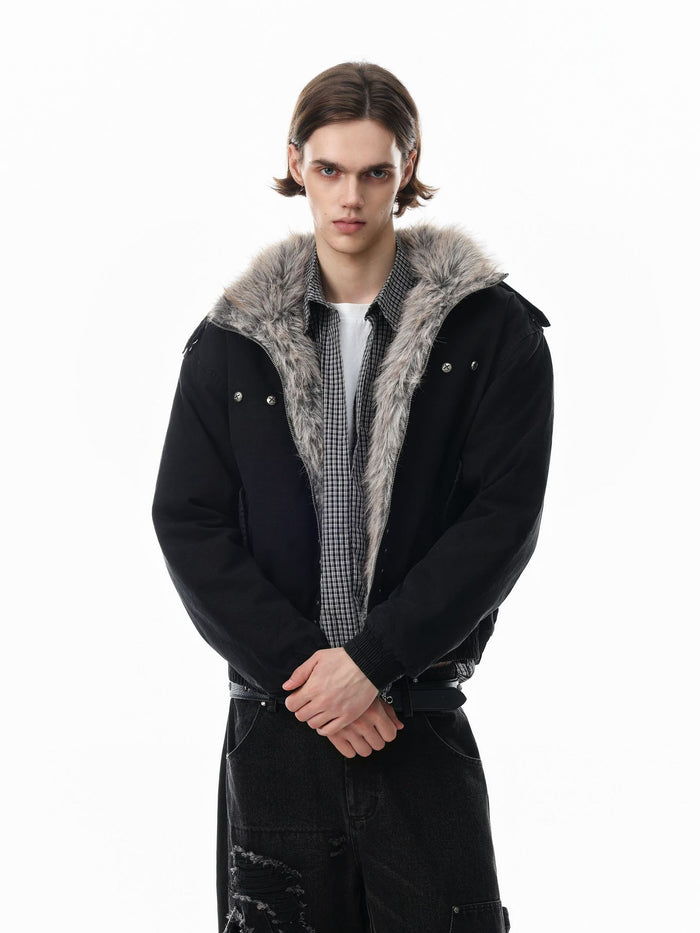 Model wearing an open black bomber jacket showing its gray faux fur collar and layered clothing