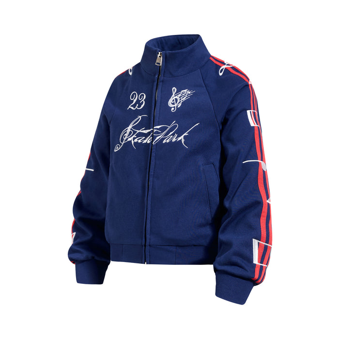 Angled front view of a navy blue full-zip track jacket with white chest graphics and red sleeve stripes