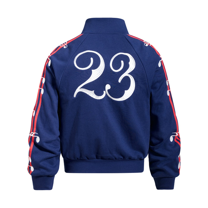 Back view of a navy blue track jacket with a large white number 23 and red-and-white sleeve detailing