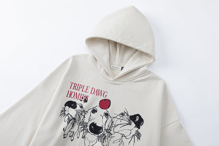 Close-up of a cream hoodie hood and front dog graphic with red Triple Dawg Homies lettering