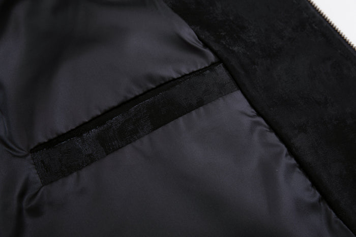Close-up of the jacket interior showing smooth black lining, seam binding, and velvet outer edge