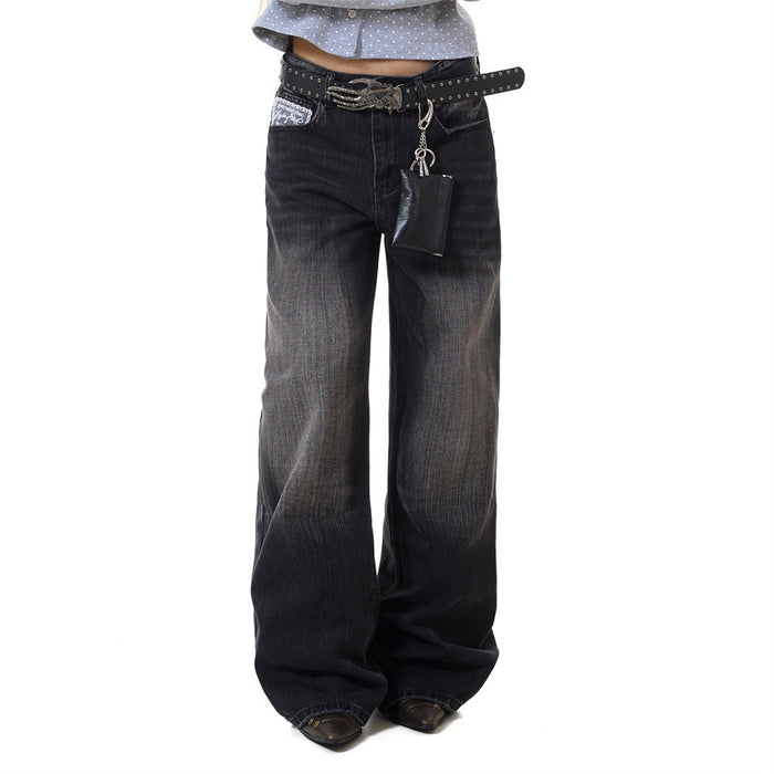 Black vintage washed wide-leg jeans worn in a front view with a belt and hanging accessories