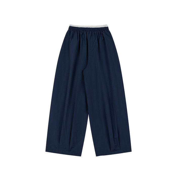 Navy wide-leg pants shown from the back with a white double waistband and plain legs