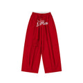 Red wide-leg pants shown from the front with a white double waistband and script embroidery