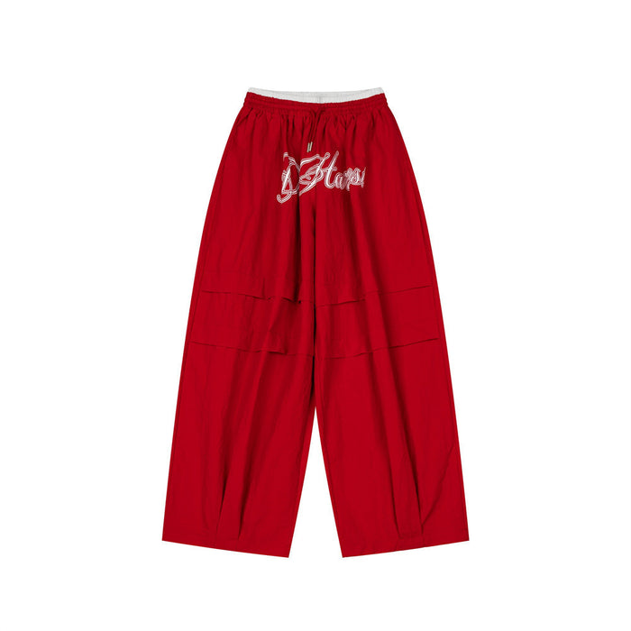 Red wide-leg pants shown from the front with a white double waistband and script embroidery
