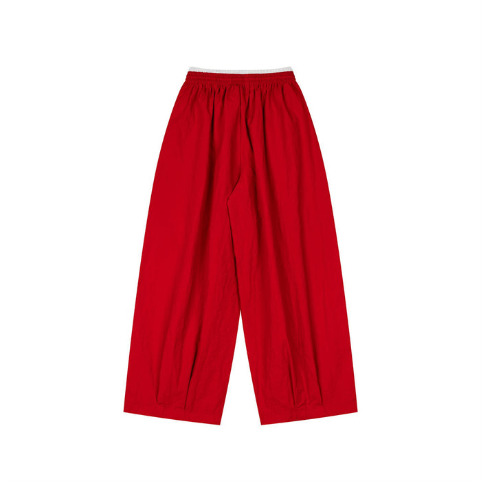 Red wide-leg pants shown from the back with a white double waistband and plain wide legs