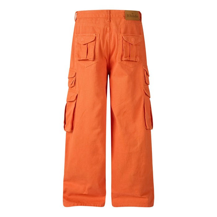 Back view of orange wide-leg cargo pants showing two flap back pockets and side cargo pockets