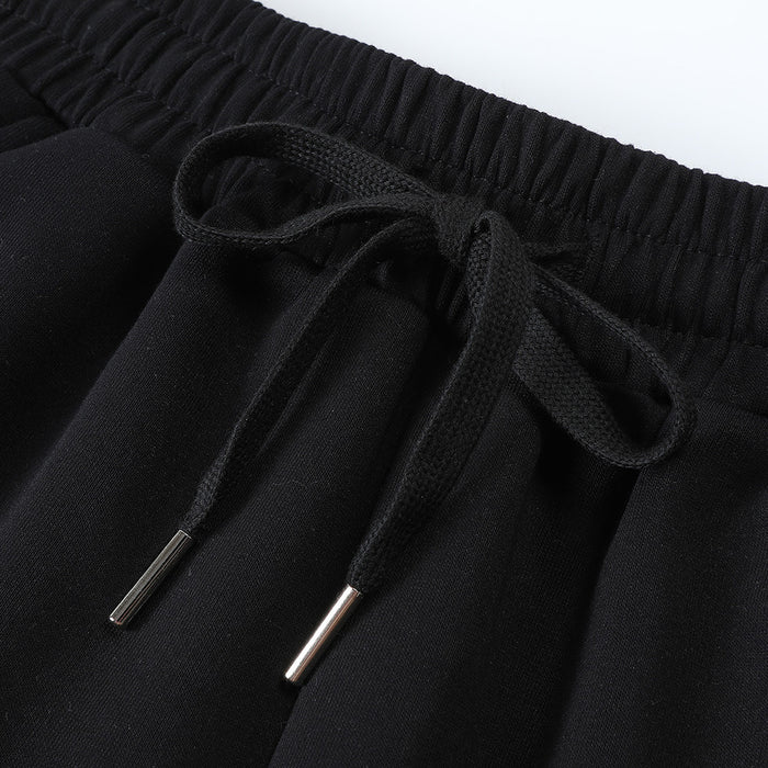 Detailed view of black elastic waistband and drawstring with silver-colored metal tips