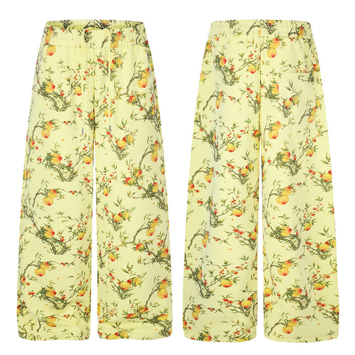 Wide-leg pants shown front and back in pale yellow with an all-over peach blossom branch print