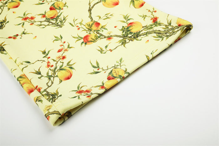 Close-up of the folded pant hem with pale yellow peach blossom branch fabric and stitched edge