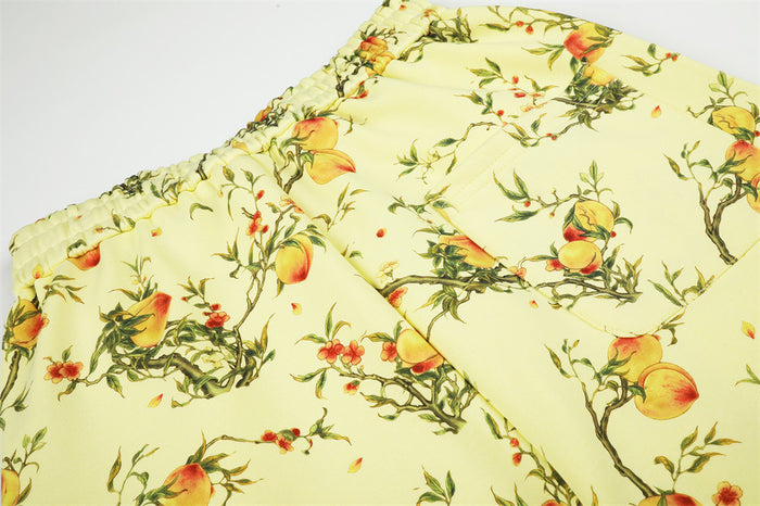 Close-up of the elastic waistband and upper leg featuring the all-over peach branch print