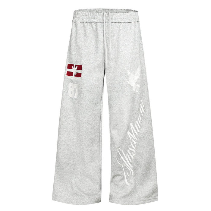 Gray wide-leg sweatpants front view with drawstring waist, red letter patch, white Pegasus and script graphics