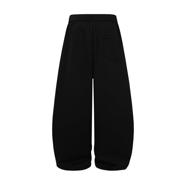 Black wide-leg sweatpants shown from the back with an elastic waistband and single rear patch pocket