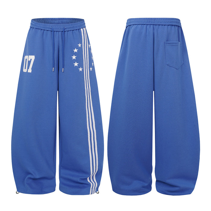 Blue wide-leg sweatpants shown side by side from front and back, featuring striped star-print front and rear pocket