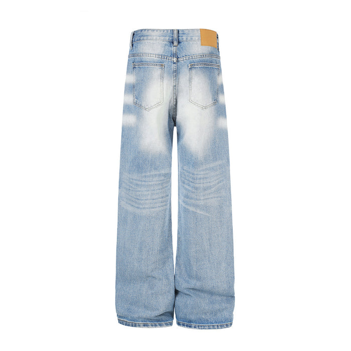 Back view of wide-leg light blue washed jeans with two rear patch pockets and a tan waistband label