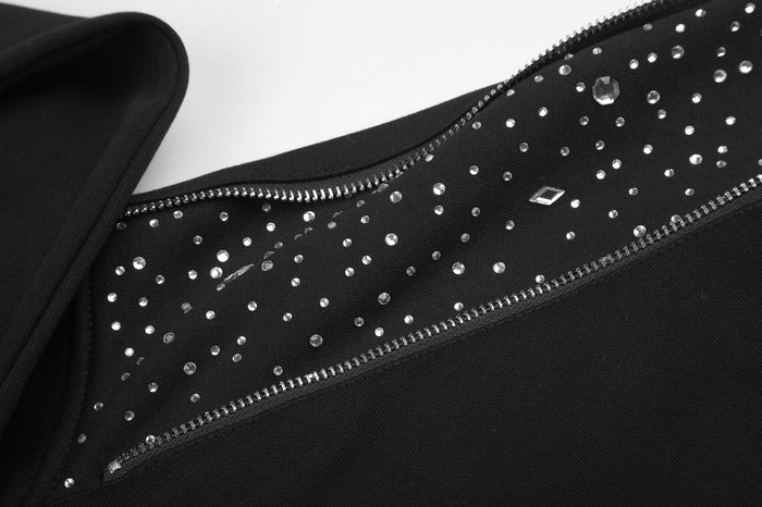 Close-up of the black hoodie’s shoulder panel covered with scattered silver rhinestones and bordered by zipper teeth