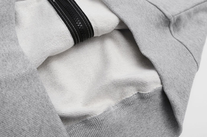 Close-up of the hoodie interior showing soft brushed lining, gray fabric, and black zipper tape